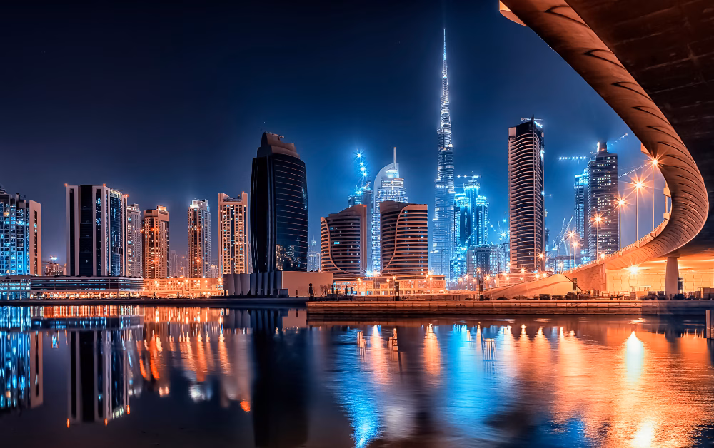 Dubai skyline illuminated at night, viewed from above